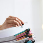 Employee working with documents in office, closeup.