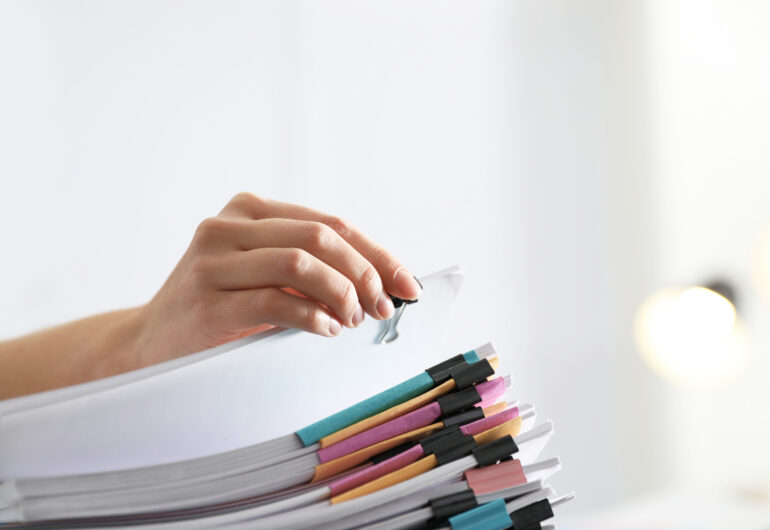 Employee working with documents in office, closeup.