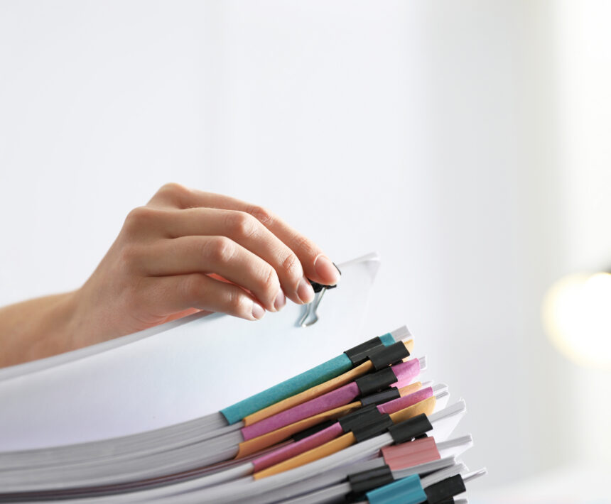 Employee working with documents in office, closeup.
